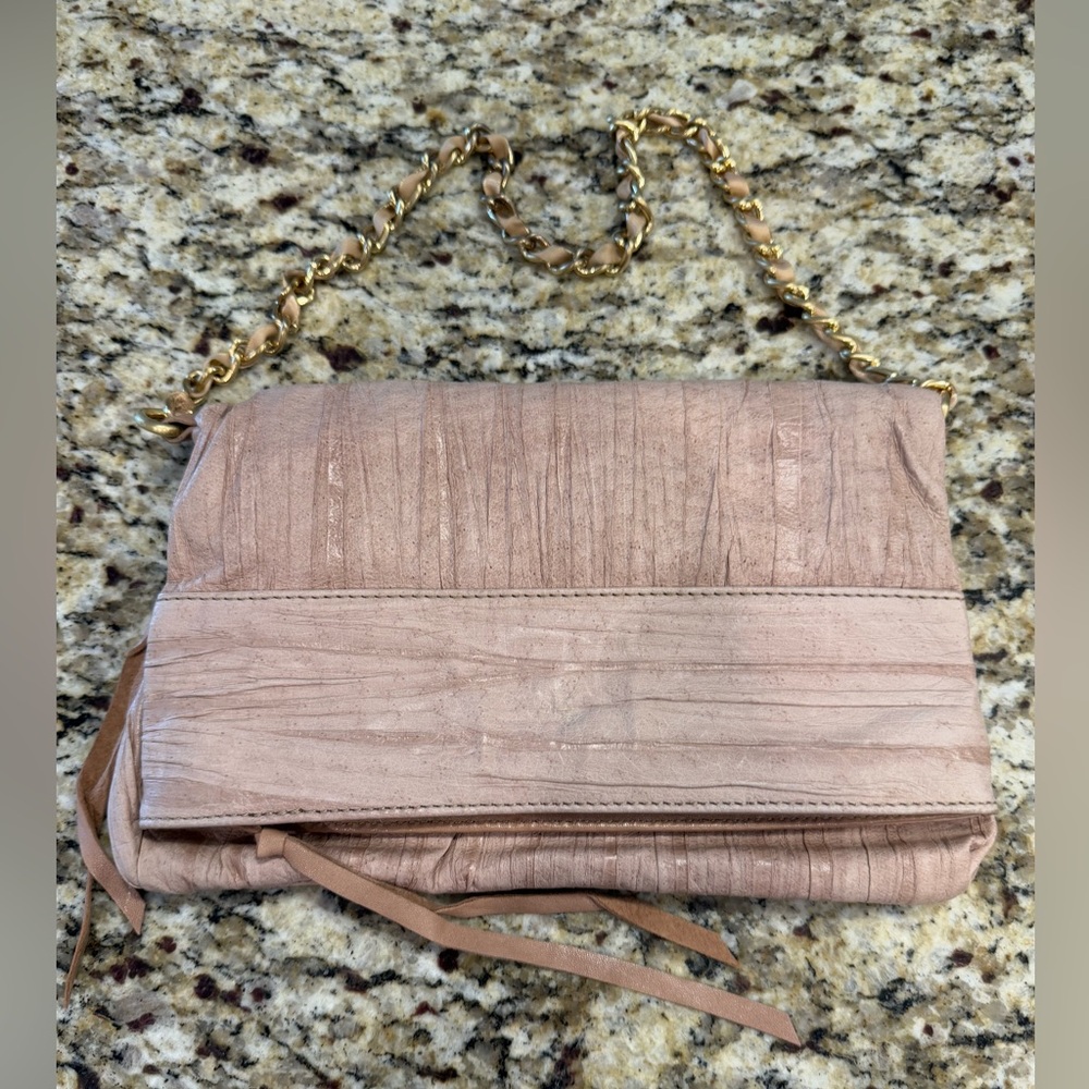 Pink leather clutch shoulder bag with a gold chain & floral cloth compartments